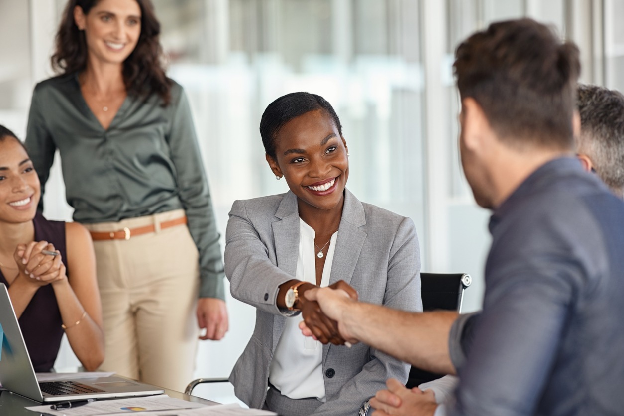 A businesswoman shaking hands with client