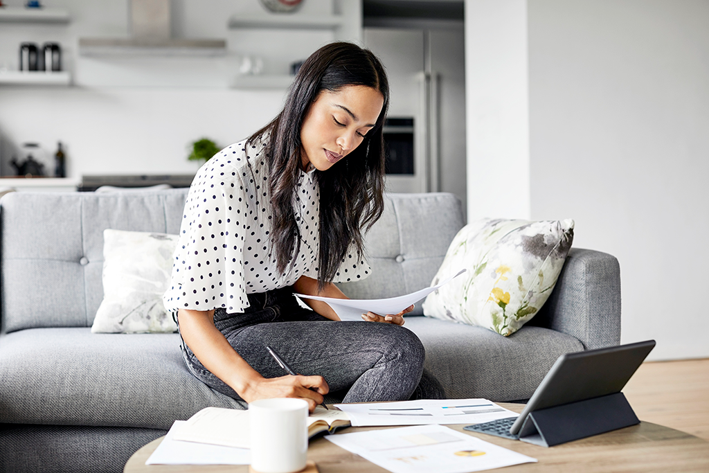 Picture of a woman studying at home with a laptop.